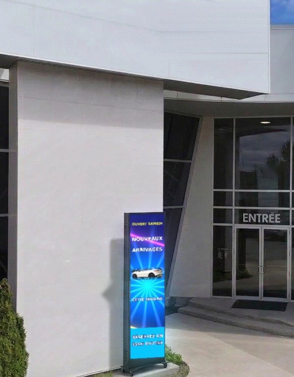 Affiche DEL sur pied à roulettes à l’entrée vitrée d’un commerce