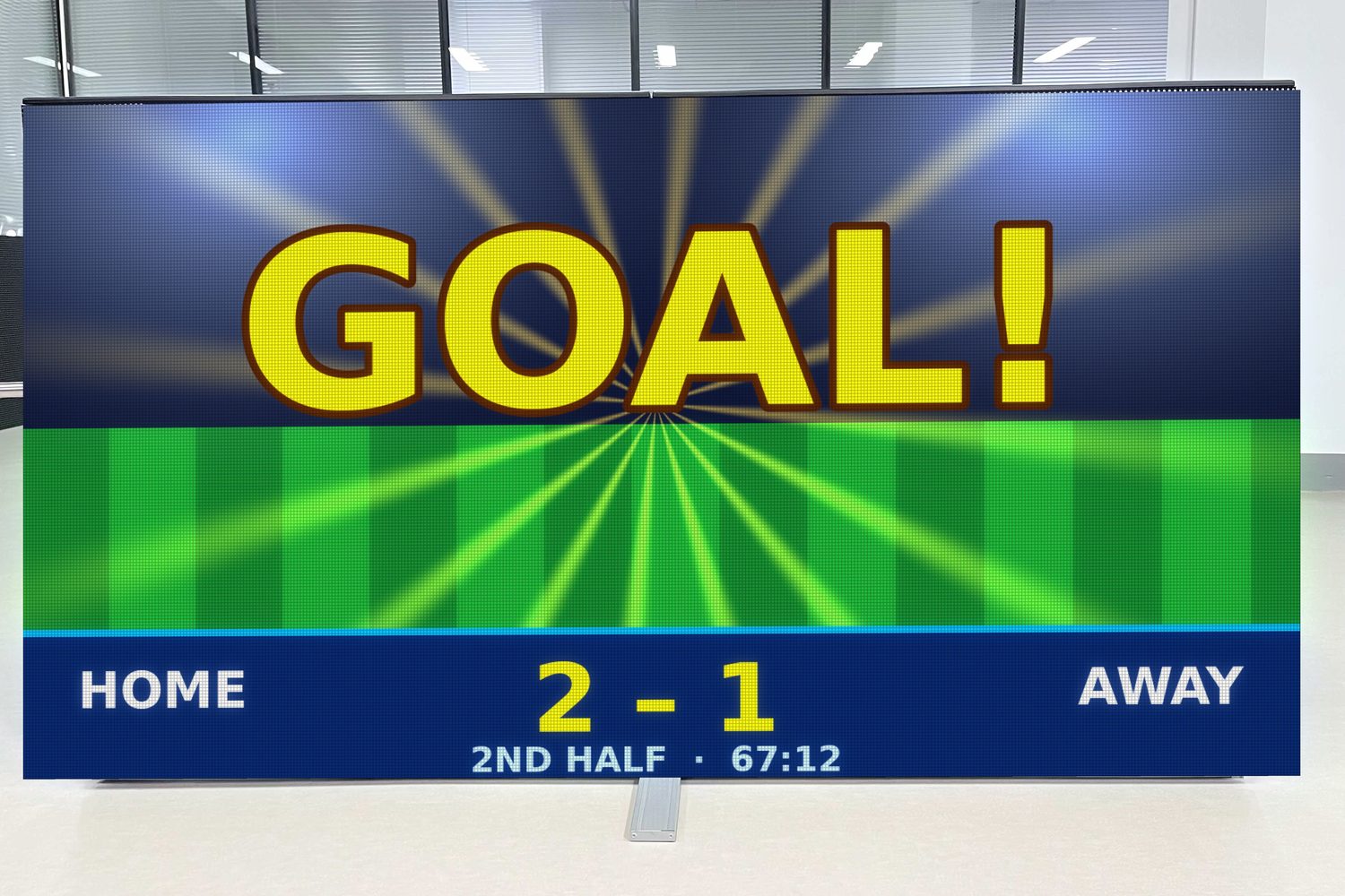 Lit sports LED screen showing a goal and the score